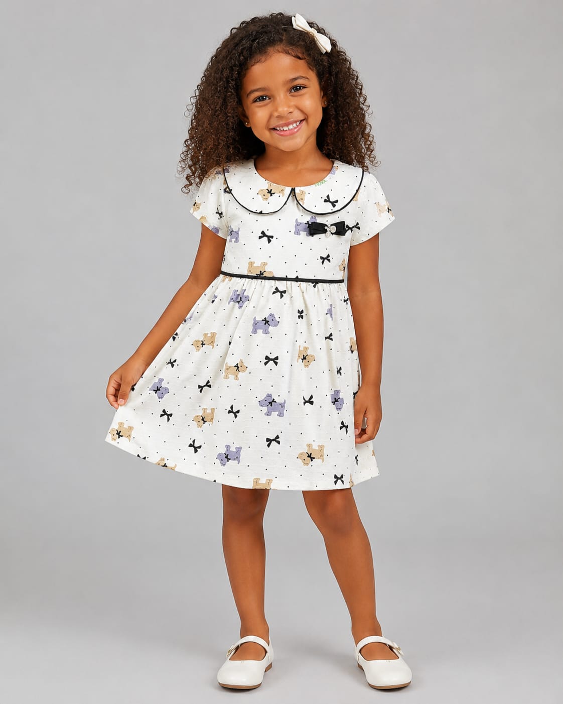 Vestido Infantil em Malha Nikko Estampado com Gola Boneca e Laço