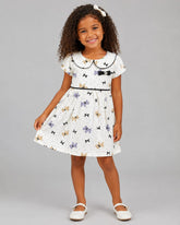 Vestido Infantil em Malha Nikko Estampado com Gola Boneca e Laço